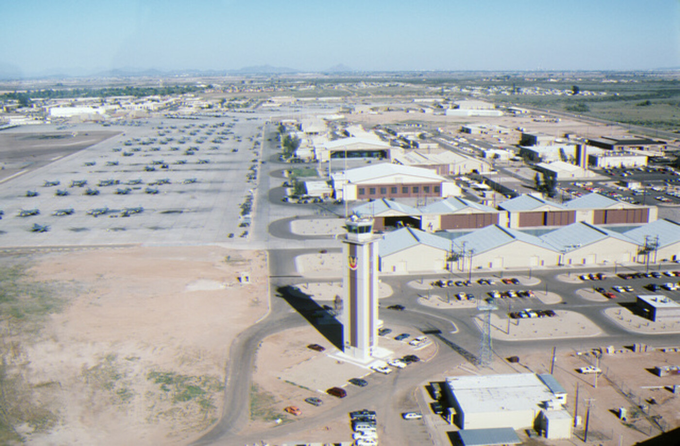 USAF flight line with control tower, hangars, and parked aircraft